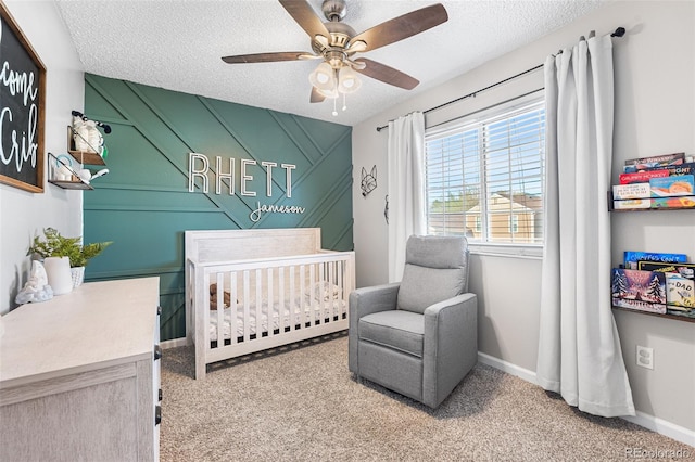 4733 S Vivian Ct, Morrison, CO 80465 - bedroom with a crib, a textured ceiling, carpet floors, baseboards, and a ceiling fan