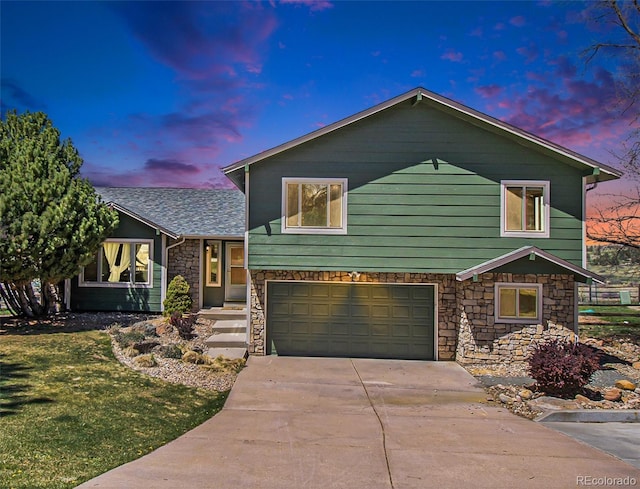 7701 Hillgate Way, Parker, CO 80134 - tri-level home with roof with shingles, stone siding, a garage, a front yard, and driveway