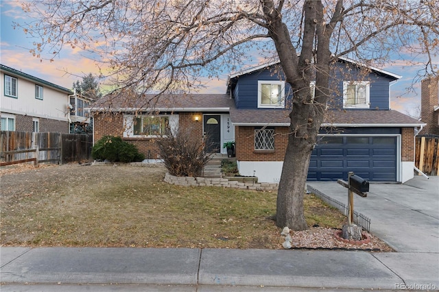 view of front of home featuring a garage and a yard