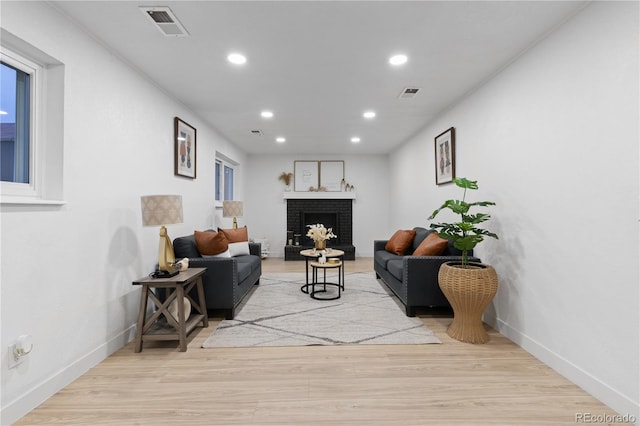 living room with a fireplace and light hardwood / wood-style floors