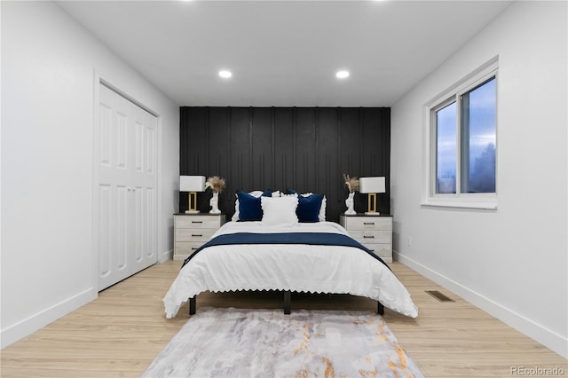 bedroom with a closet and light hardwood / wood-style flooring