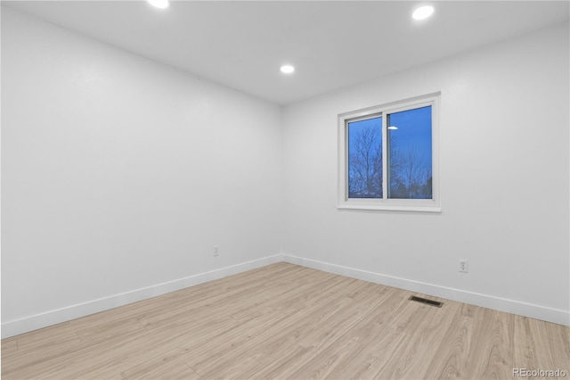 spare room featuring light wood-type flooring