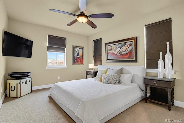 bedroom with ceiling fan and light carpet