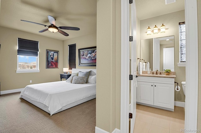 bedroom featuring sink and ceiling fan