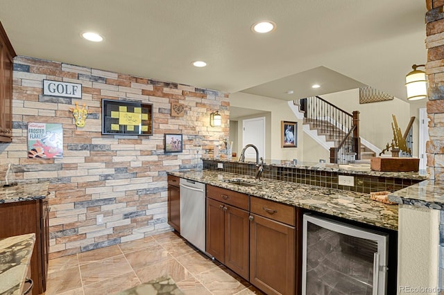 kitchen featuring beverage cooler, dishwasher, sink, and stone counters