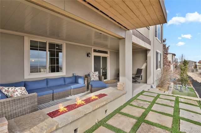 view of patio / terrace with an outdoor living space with a fire pit