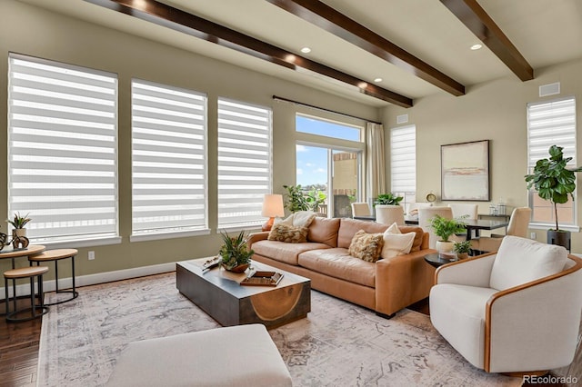 living room with beam ceiling and light wood-type flooring