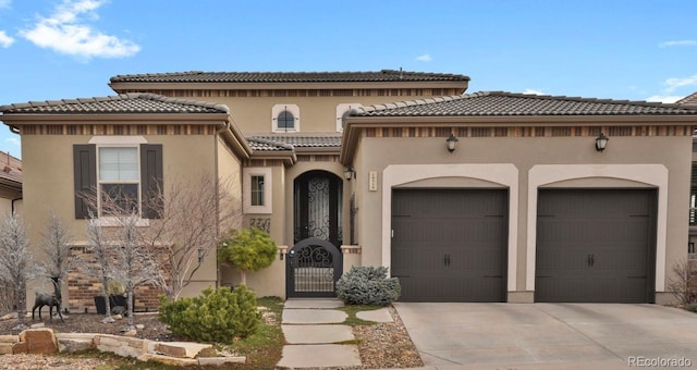 mediterranean / spanish-style house with a garage