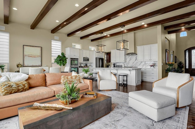 living room featuring beam ceiling and light hardwood / wood-style flooring