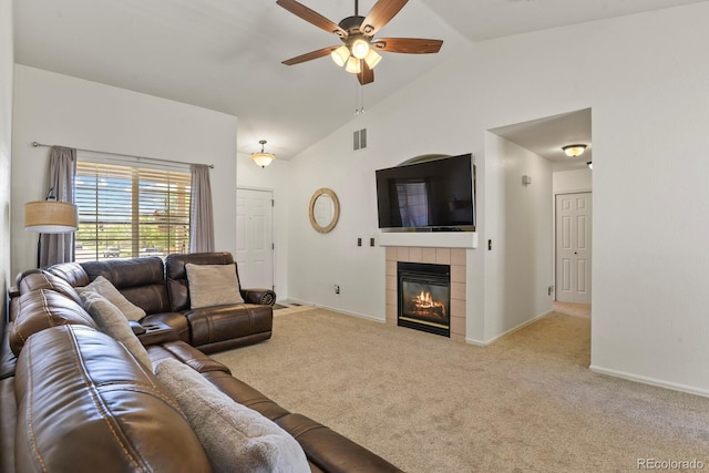 living room featuring ceiling fan, light colored carpet, lofted ceiling, and a fireplace