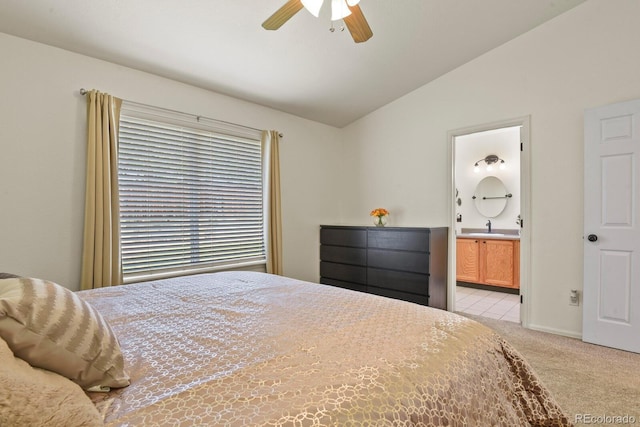 bedroom with lofted ceiling, light carpet, ensuite bathroom, sink, and ceiling fan