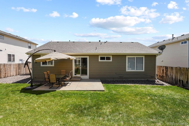 back of house featuring a lawn and a patio