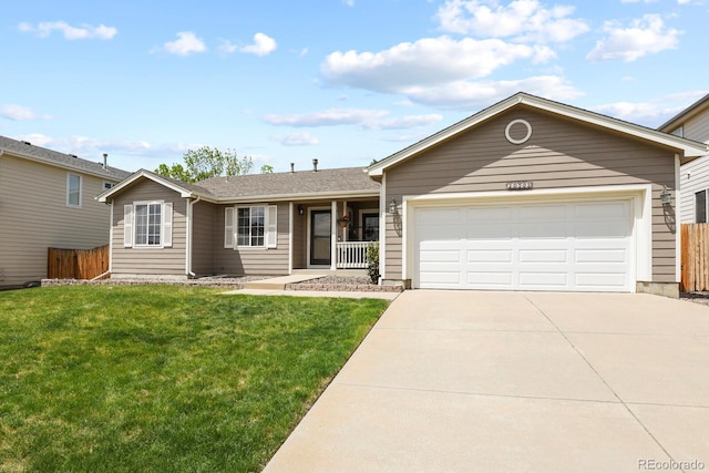 ranch-style house with fence, an attached garage, a front lawn, and concrete driveway