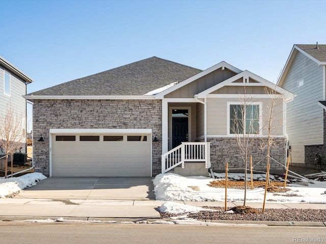 view of front of property with a garage and central air condition unit