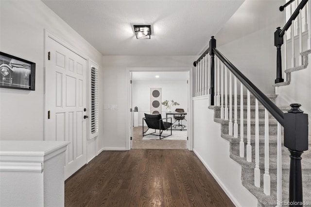 entryway with dark hardwood / wood-style flooring and a textured ceiling