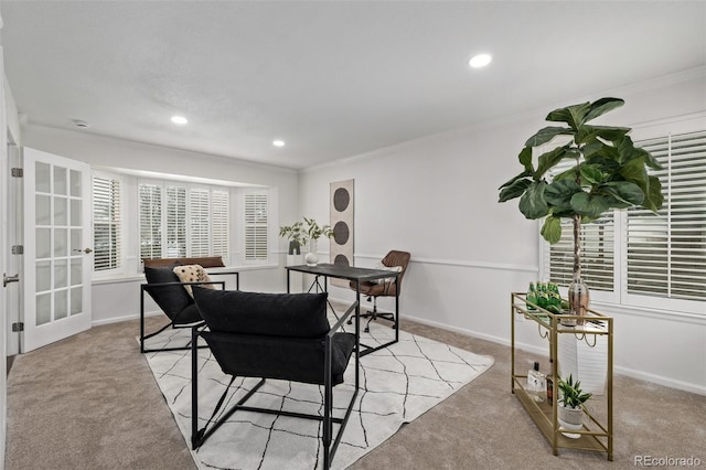 dining room with crown molding and light carpet