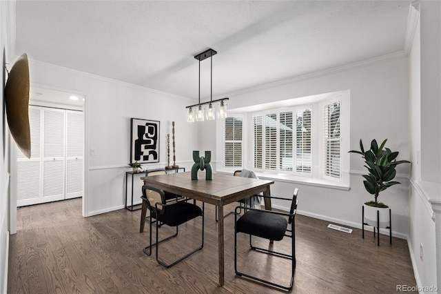 dining space with crown molding and dark hardwood / wood-style flooring