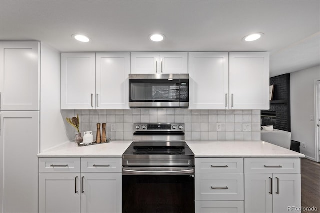 kitchen featuring white cabinetry, appliances with stainless steel finishes, and decorative backsplash