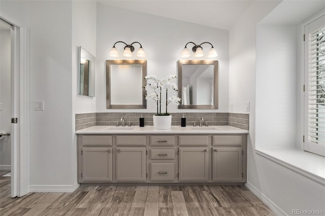 bathroom with hardwood / wood-style flooring, vanity, lofted ceiling, and decorative backsplash