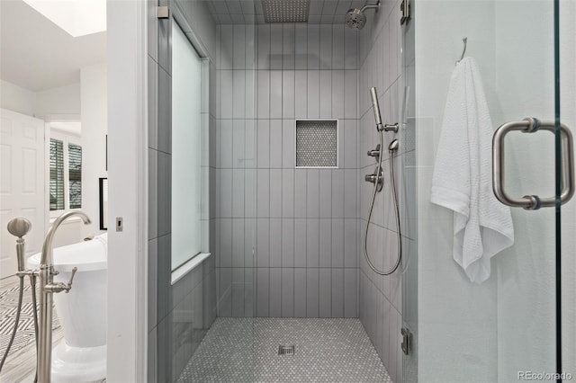 bathroom featuring a shower with shower door