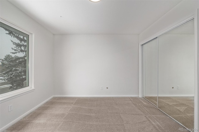 unfurnished bedroom with a closet and carpet