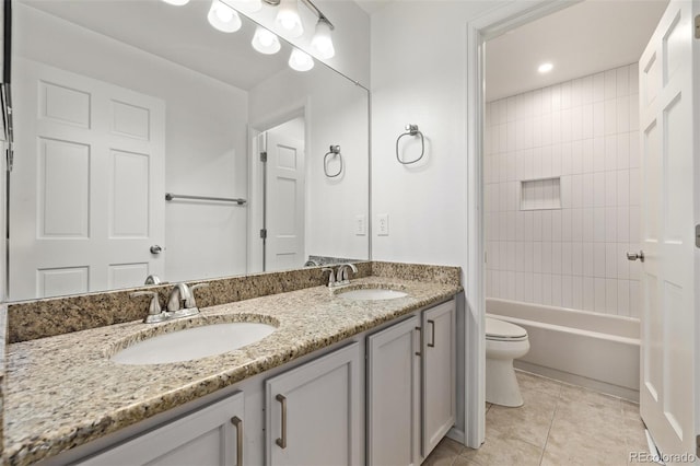 full bathroom featuring tiled shower / bath combo, vanity, tile patterned floors, and toilet