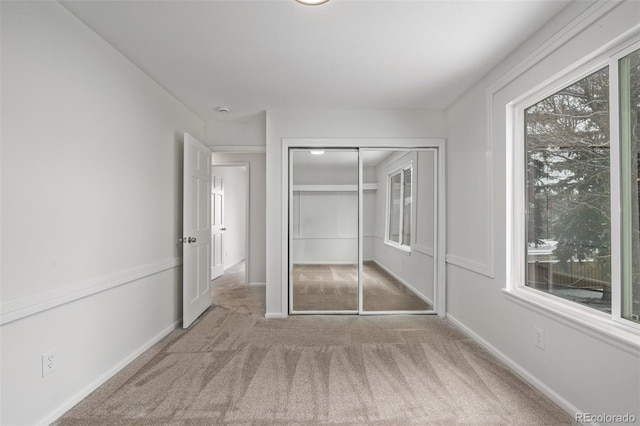 unfurnished bedroom featuring carpet floors and a closet