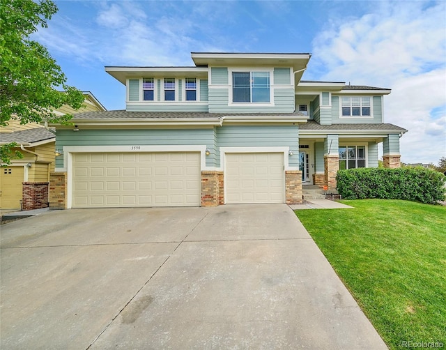 3590 S Malaya St, Aurora, CO 80013 - prairie-style house featuring driveway, brick siding, and a front lawn