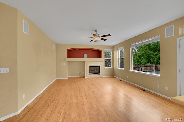 3590 S Malaya St, Aurora, CO 80013 - unfurnished living room featuring a ceiling fan, wood finished floors, a tile fireplace, and baseboards