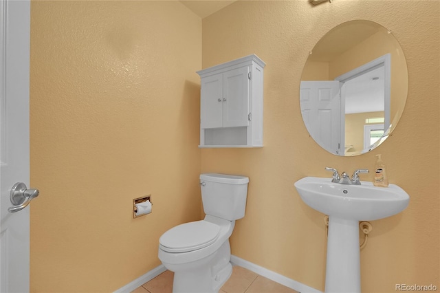 3590 S Malaya St, Aurora, CO 80013 - half bath with tile patterned flooring, toilet, baseboards, and a sink