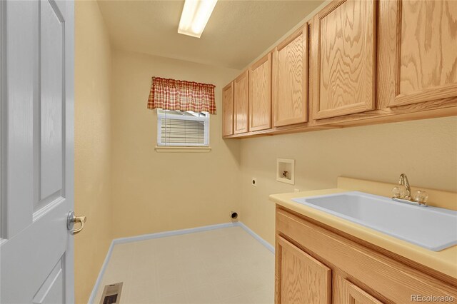 3590 S Malaya St, Aurora, CO 80013 - washroom with hookup for an electric dryer, hookup for a washing machine, cabinet space, and baseboards