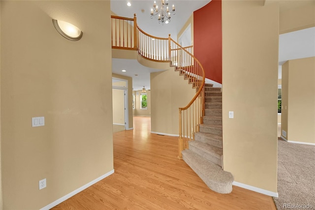 3590 S Malaya St, Aurora, CO 80013 - entrance foyer with a chandelier, baseboards, stairway, wood finished floors, and a towering ceiling