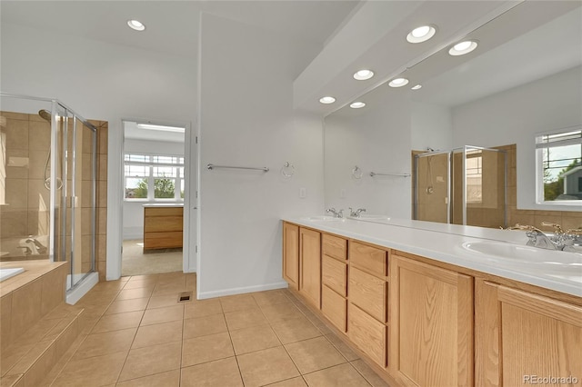 3590 S Malaya St, Aurora, CO 80013 - bathroom with healthy amount of natural light, a shower stall, tile patterned floors, recessed lighting, and a bath