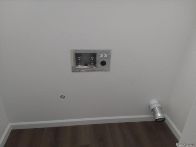 laundry area featuring wood finished floors, hookup for a washing machine, and baseboards