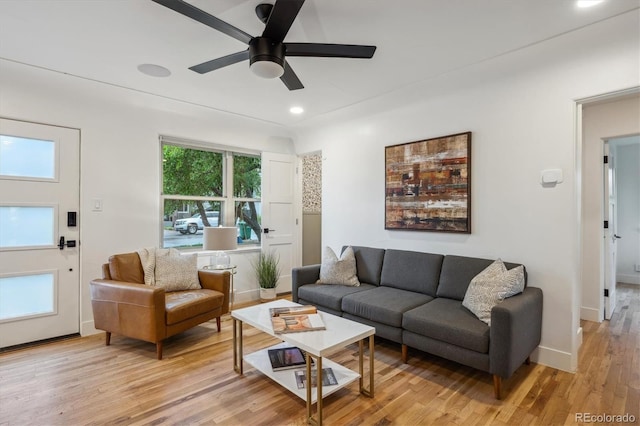 living area featuring a ceiling fan, light wood-style flooring, recessed lighting, and baseboards