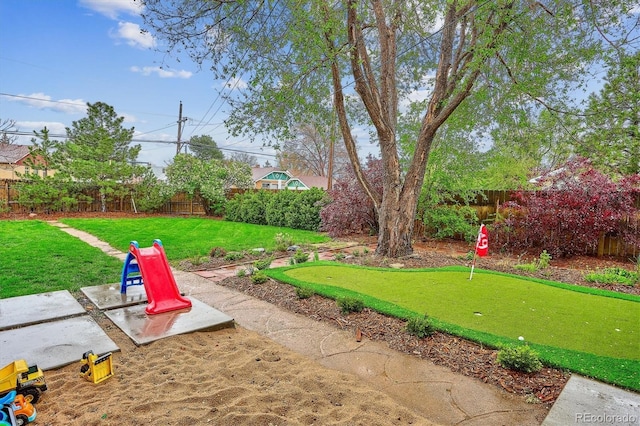 view of yard featuring a putting green and a patio