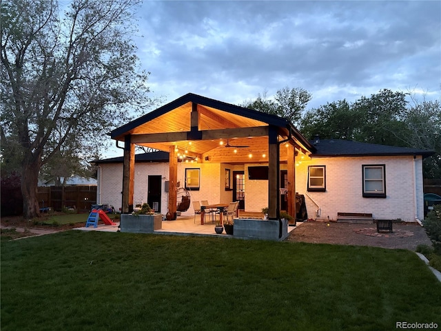 back of property with brick siding and a patio area