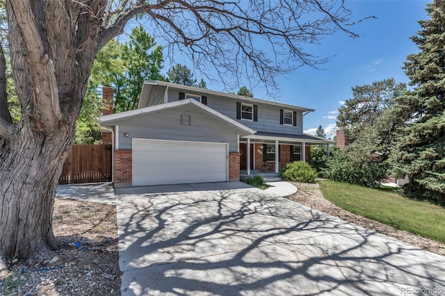 8696 E Easter Ave, Centennial, CO 80112 - traditional-style home featuring brick siding, covered porch, an attached garage, concrete driveway, and a chimney