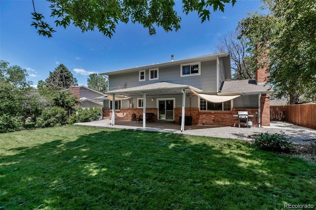 8696 E Easter Ave, Centennial, CO 80112 - rear view of property featuring a patio, brick siding, and a chimney