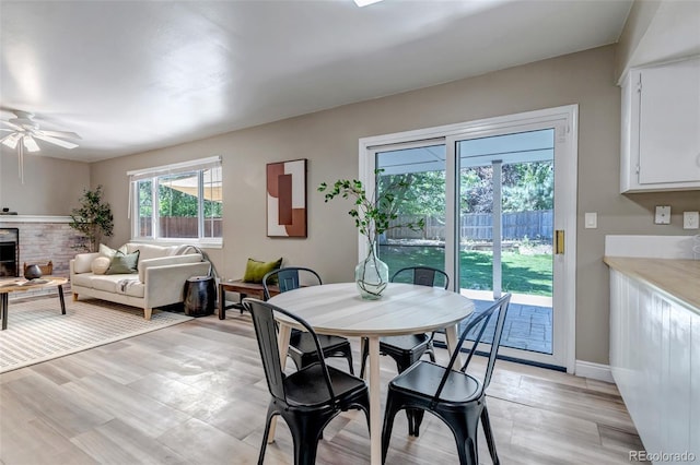 8696 E Easter Ave, Centennial, CO 80112 - dining room with a ceiling fan and a fireplace with raised hearth