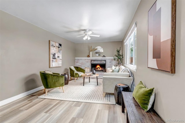 8696 E Easter Ave, Centennial, CO 80112 - living room with light wood finished floors, a fireplace, and a ceiling fan