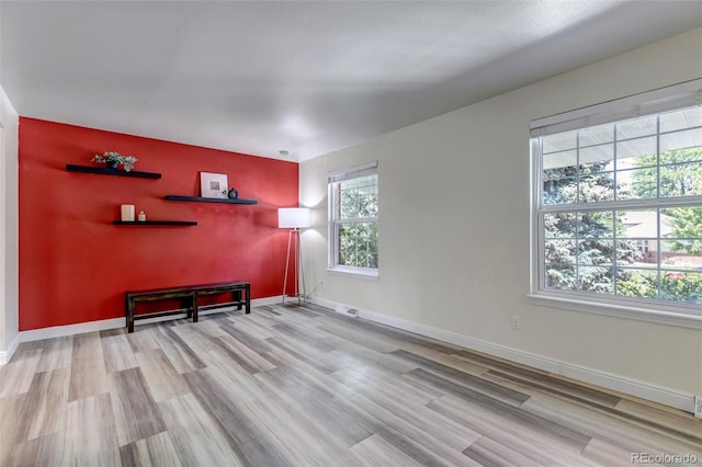 8696 E Easter Ave, Centennial, CO 80112 - living area featuring an accent wall and wood finished floors