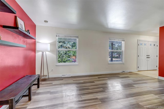 8696 E Easter Ave, Centennial, CO 80112 - unfurnished living room with wood finished floors and baseboards