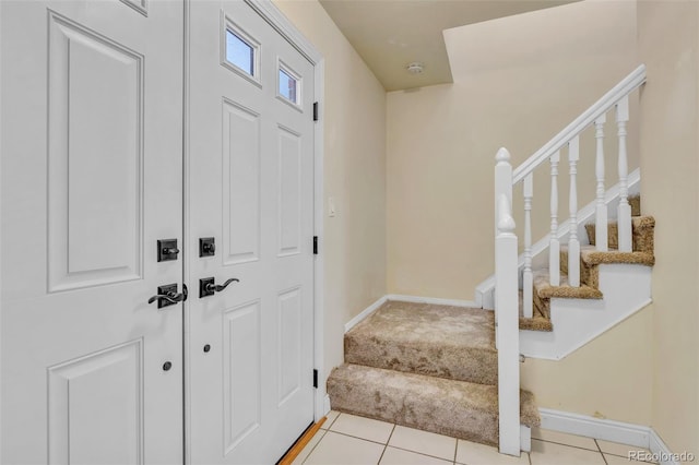 8696 E Easter Ave, Centennial, CO 80112 - entrance foyer featuring stairway, light tile patterned flooring, and light colored carpet