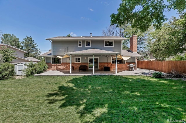8696 E Easter Ave, Centennial, CO 80112 - back of property featuring a patio, brick siding, and a chimney