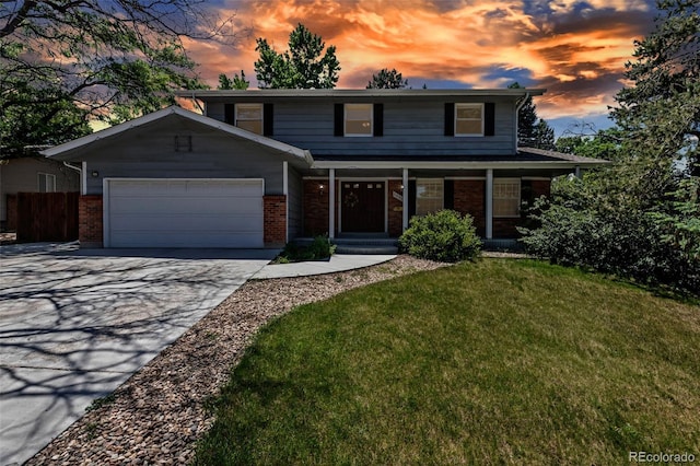 8696 E Easter Ave, Centennial, CO 80112 - traditional home with a garage, brick siding, driveway, and a porch