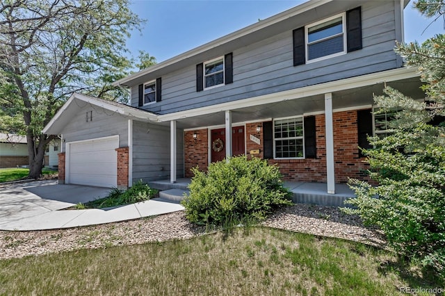 8696 E Easter Ave, Centennial, CO 80112 - view of front facade featuring brick siding, a porch, an attached garage, and driveway