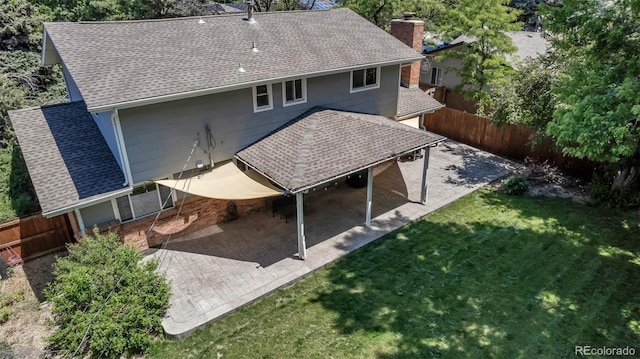8696 E Easter Ave, Centennial, CO 80112 - back of house with a shingled roof, a chimney, and a patio area