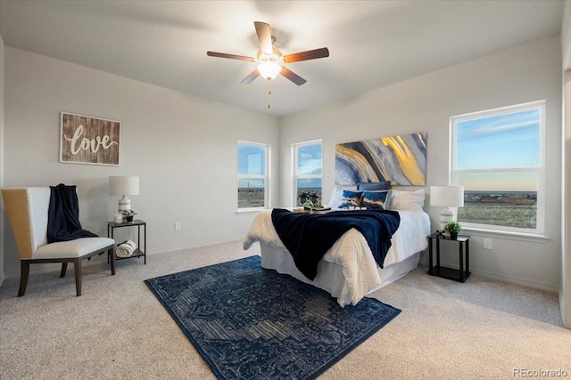 bedroom with ceiling fan, carpet, and multiple windows