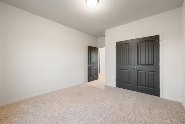 unfurnished bedroom featuring a closet and carpet flooring